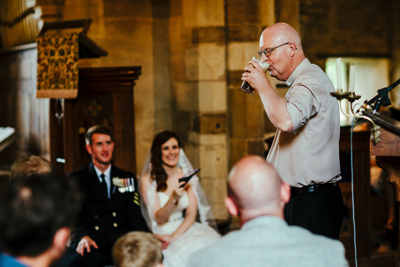 Vicar drinking beer during a wedding ceremony