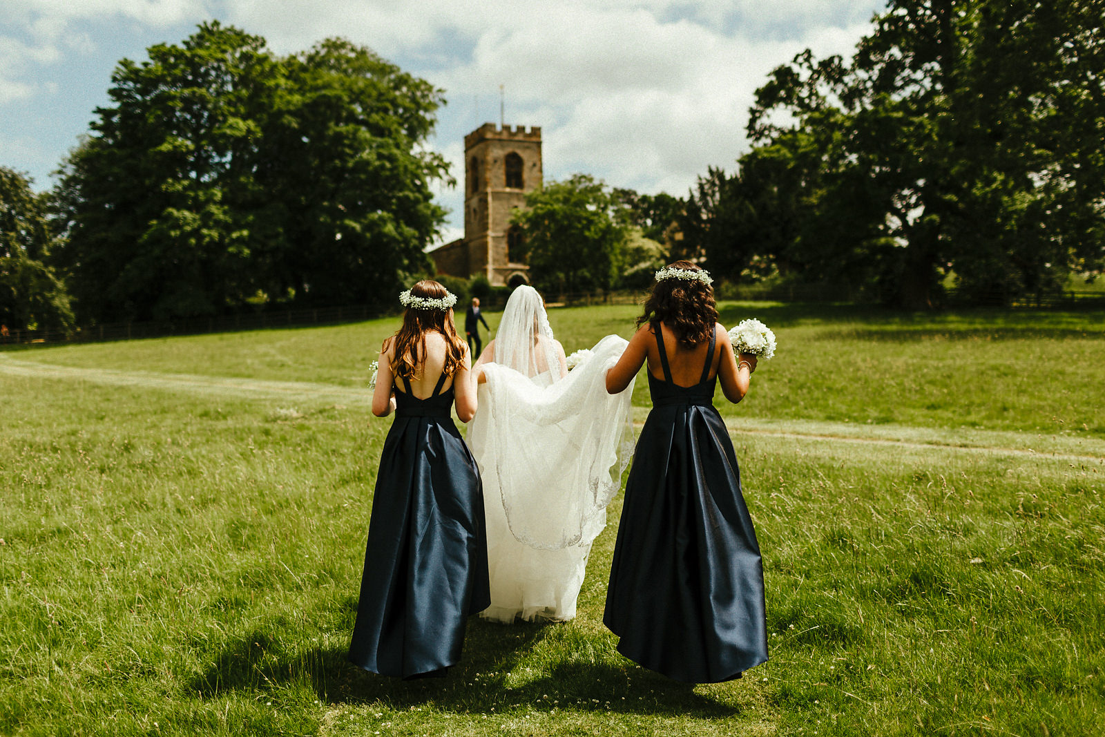 Bride walking to Courteenhall church