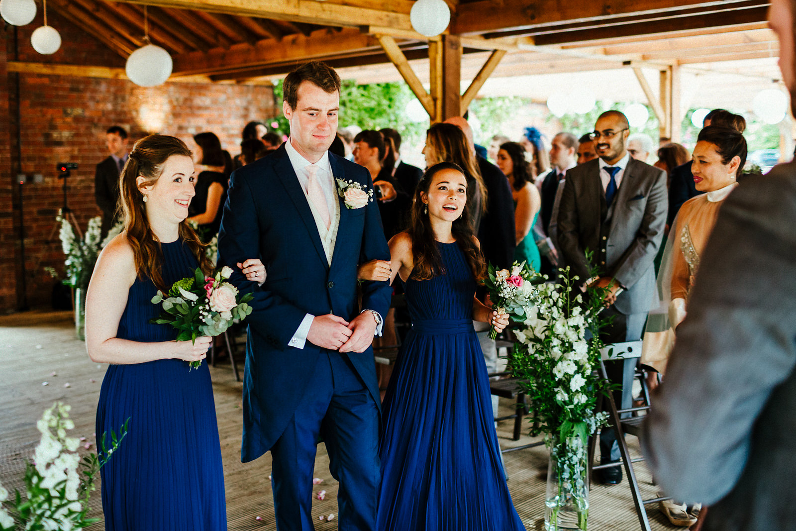 Bridesmaids walking down the aisle at Orchardleigh walled garden