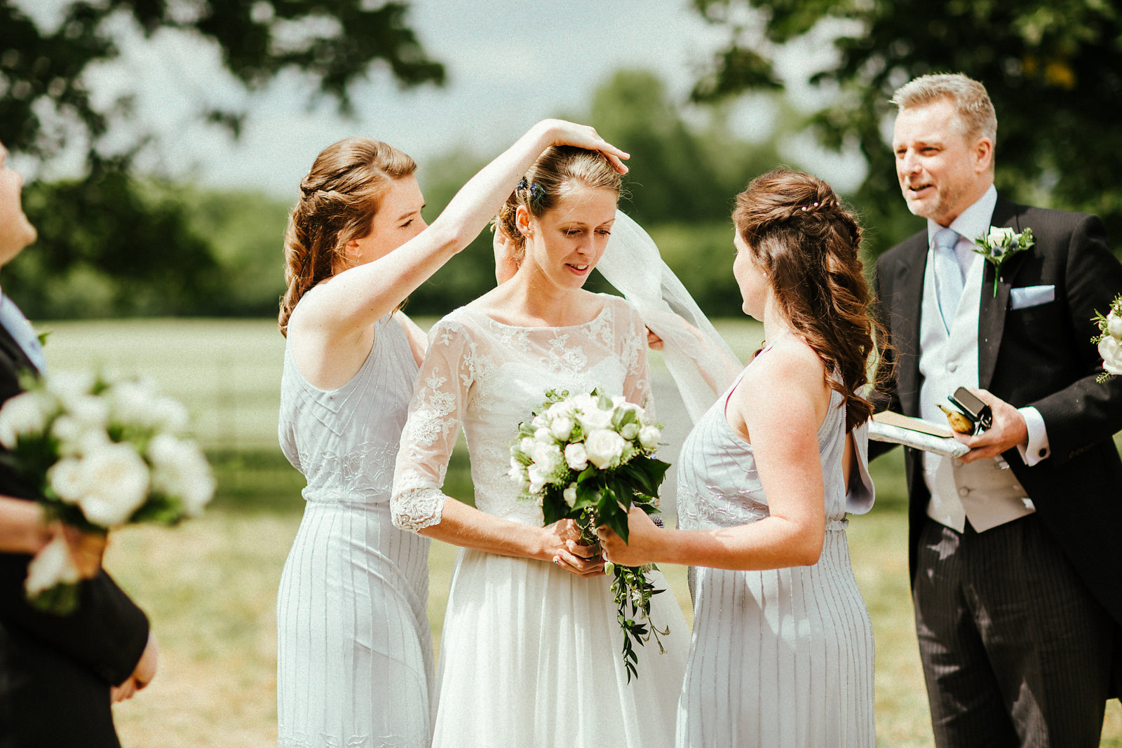 Final touches by bridesmaids on the wedding day