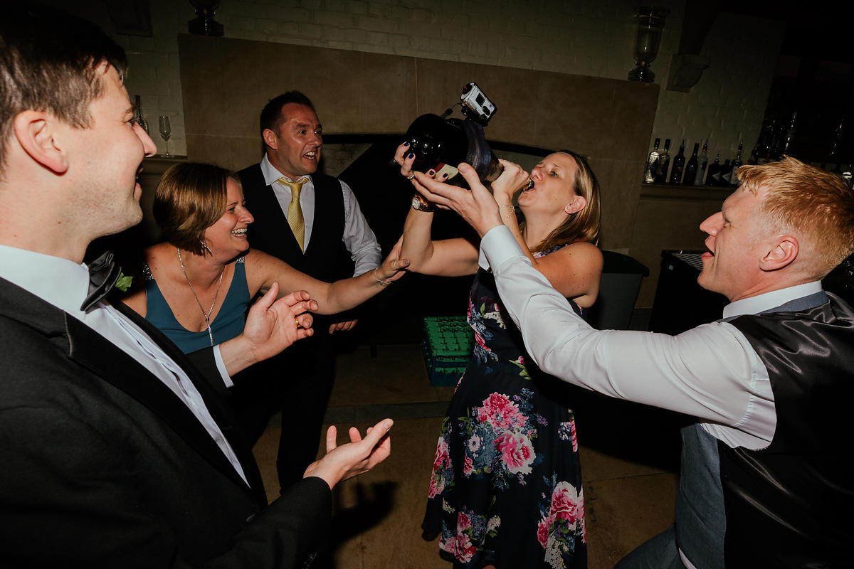 Camera recording wedding guests drinking