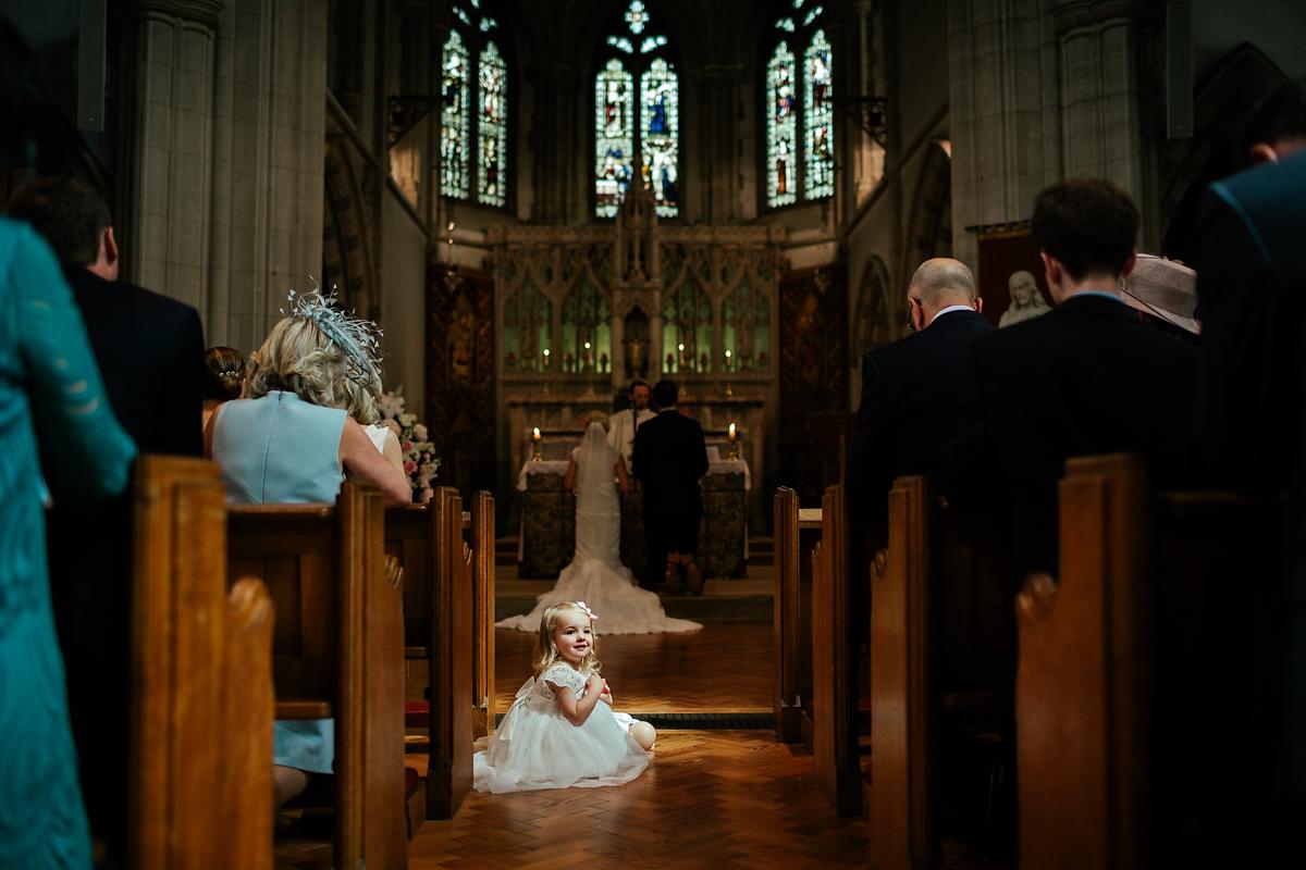 Cute flower girl during a wedding ceremony