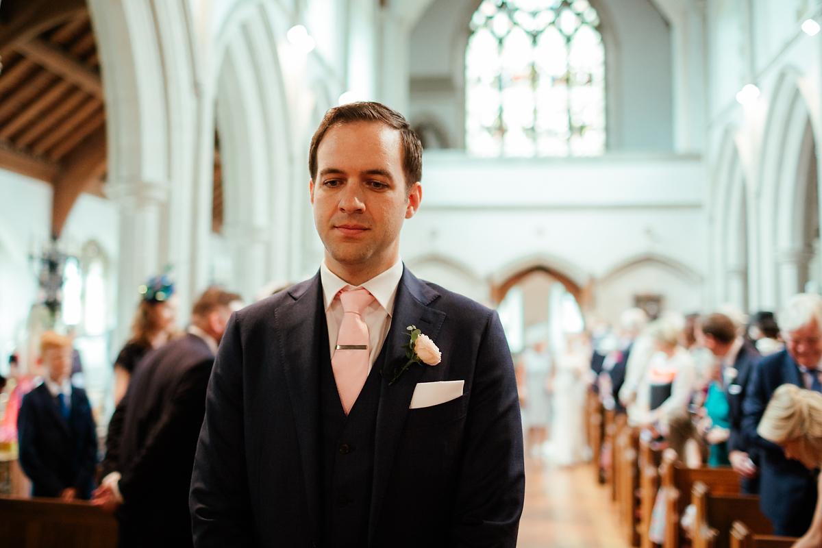 Groom waiting for his bride to walk down the isle