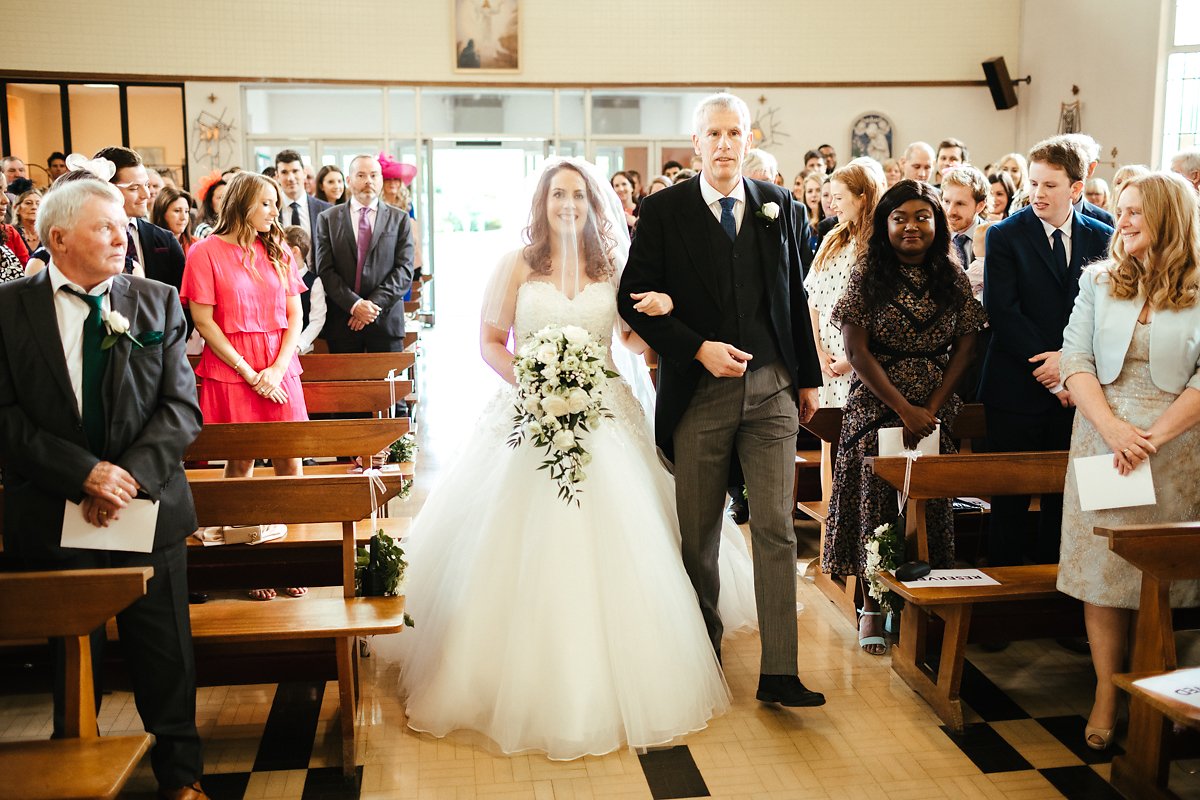 Arrival of the bride at Catholic Church wedding ceremony