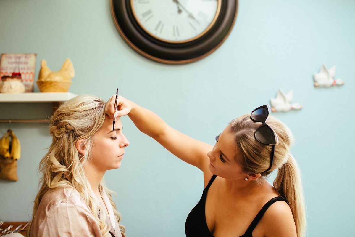 Bride getting ready with bridesmaids at home