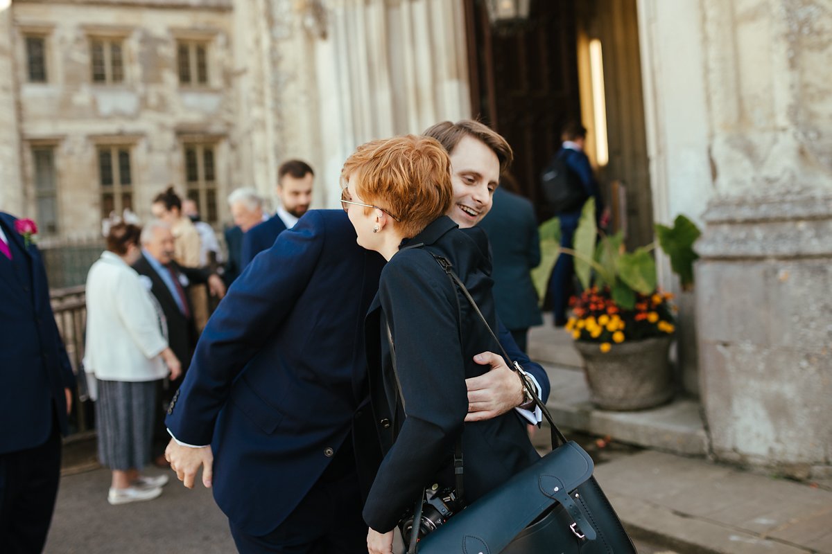 Wedding guests greeting groom