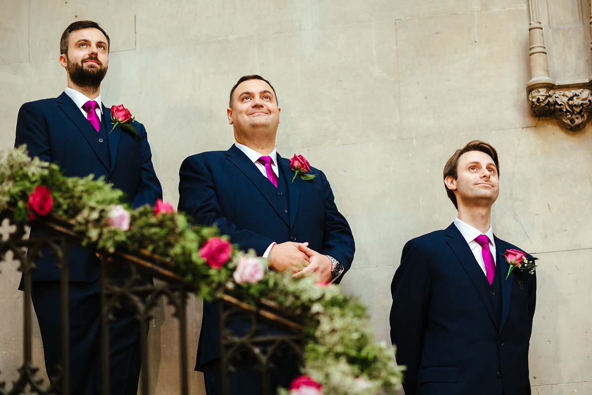 Groom waiting for his bride to walk down the stairs