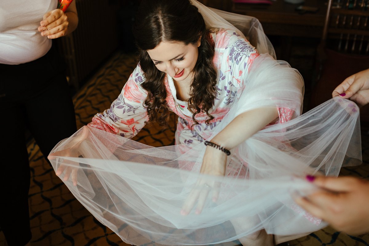 Bride getting a spider out of her veil