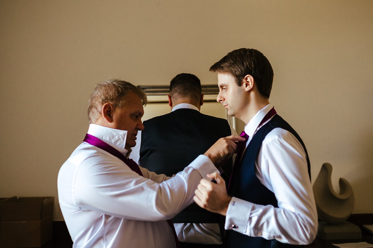 Groom getting ready with his dad at a country house