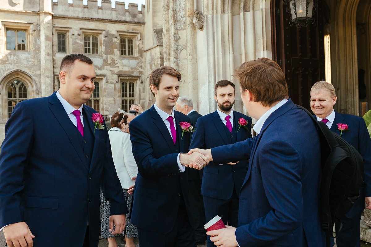 Wedding guests greeting groom