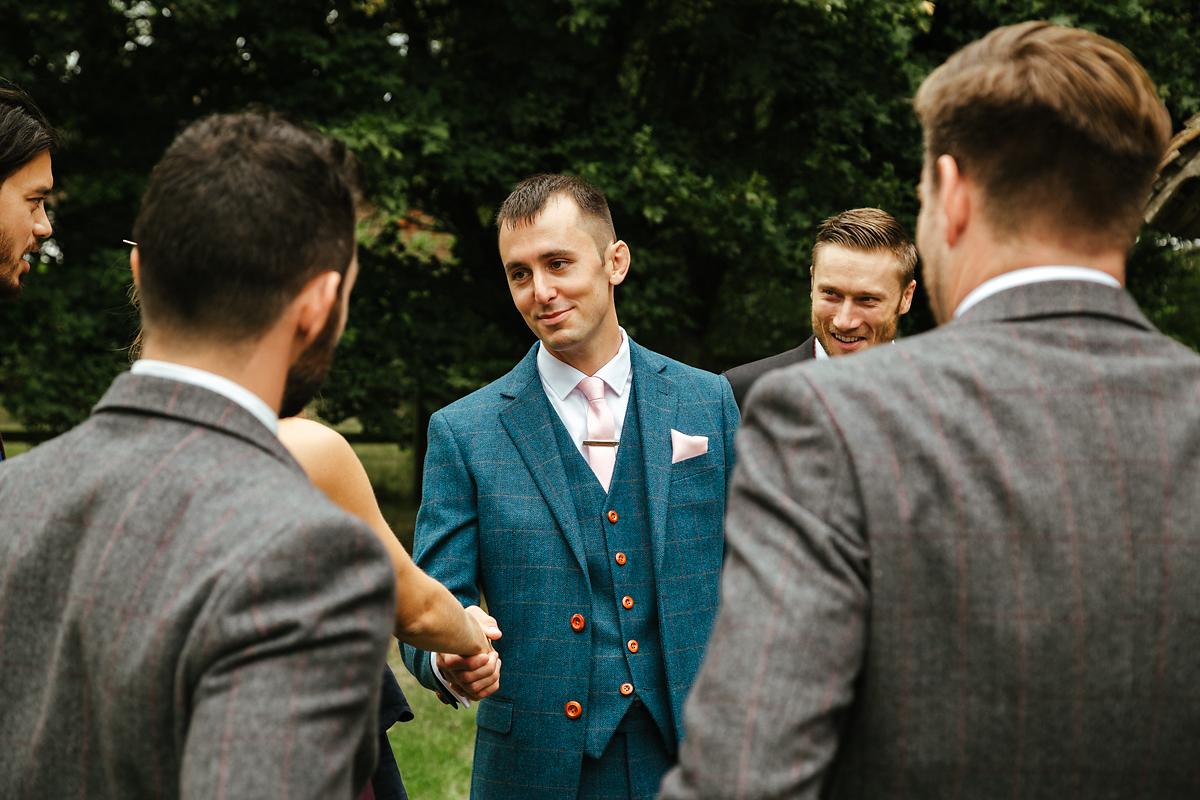 Groom walking to the church in Kent wedding