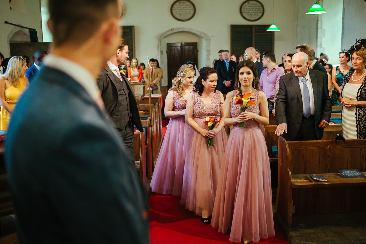 Bridesmaids walking to St Peter and St Paul Bilsington