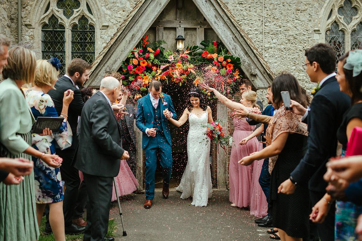 Newly married couple exit at St Peter and St Paul church in Bislington Kent