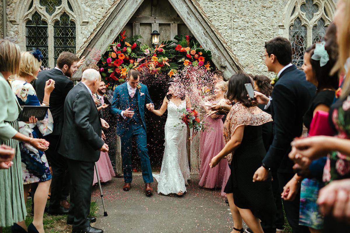 Newly married couple exit at St Peter and St Paul church in Bislington Kent