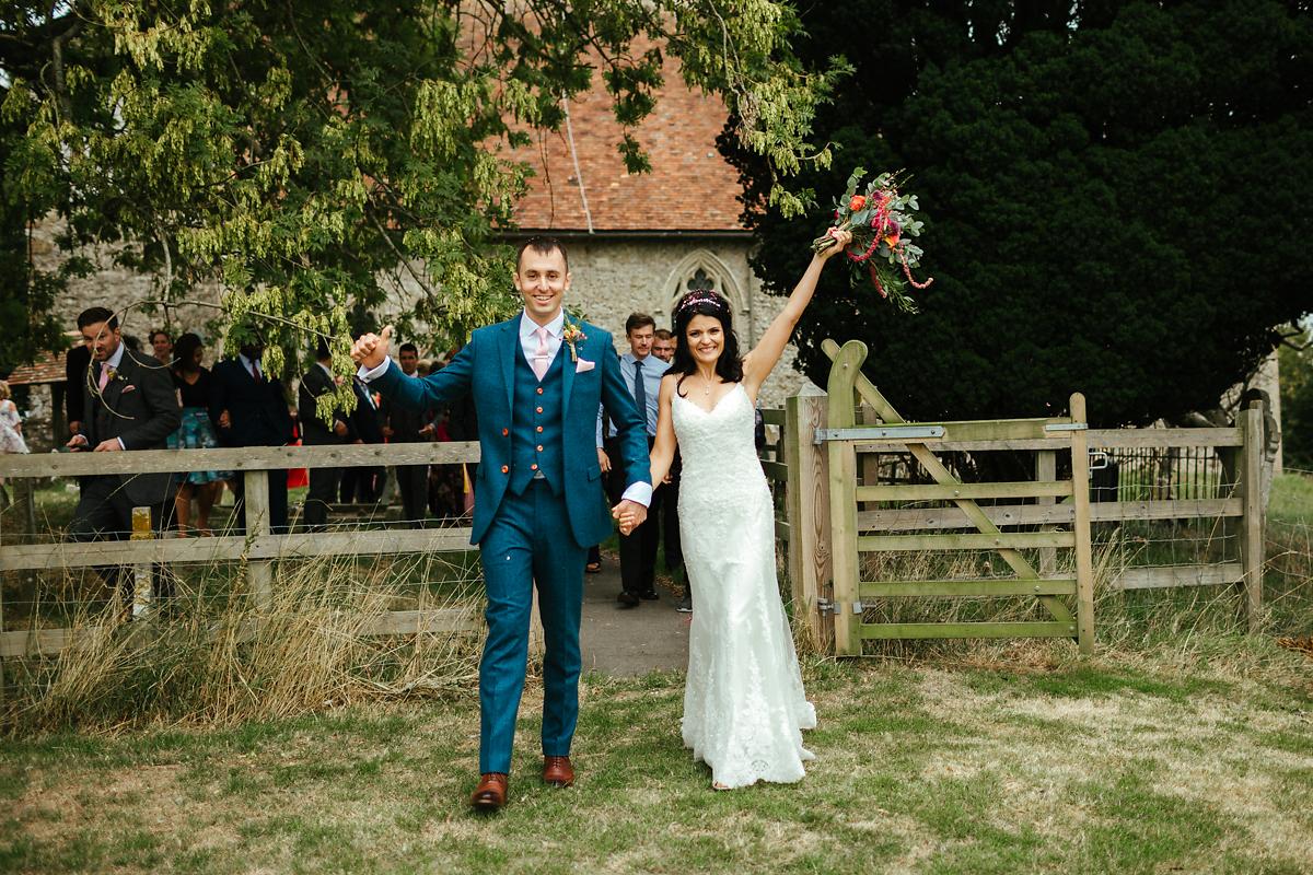 Newly married couple exit at St Peter and St Paul church in Bislington Kent