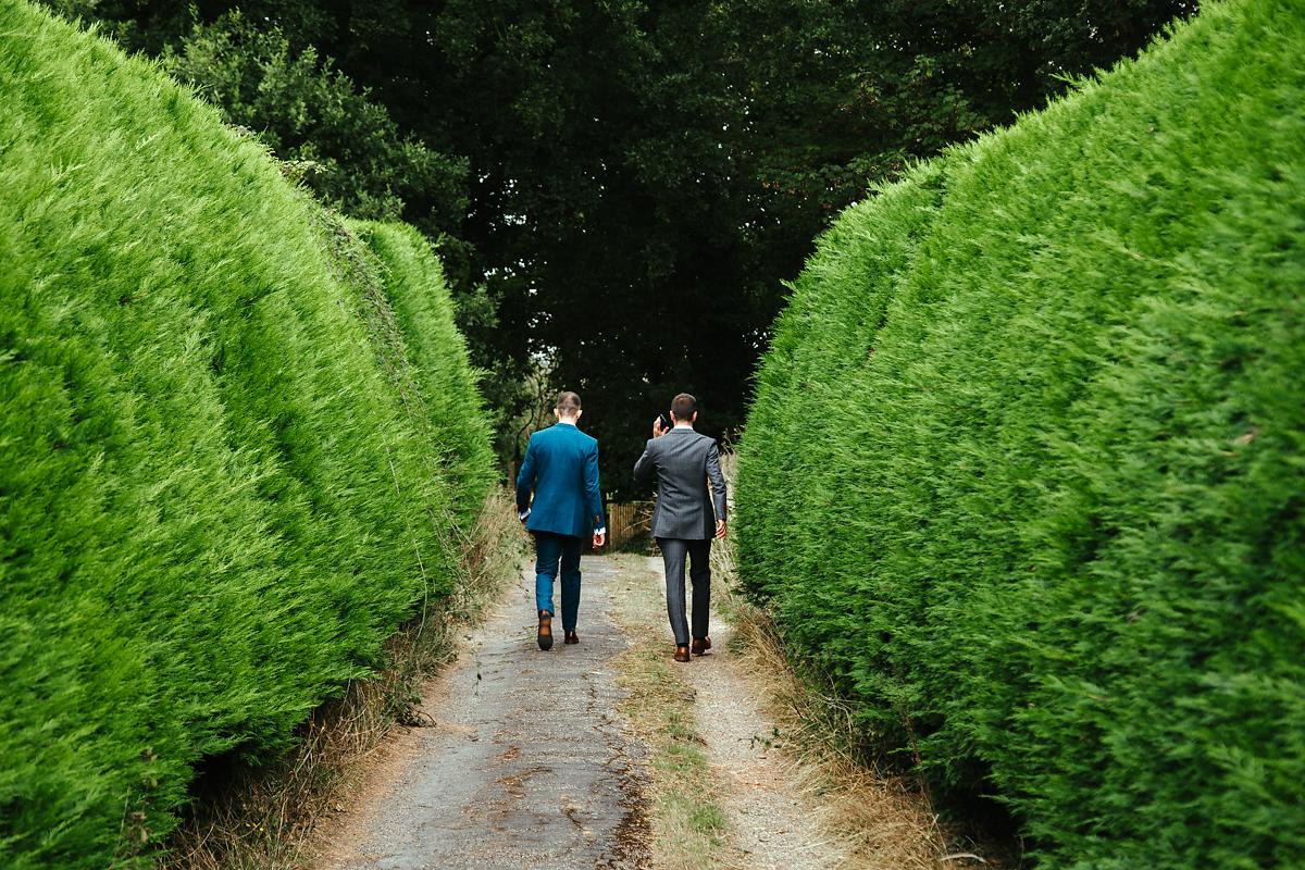 Groom walking to the church in Kent wedding