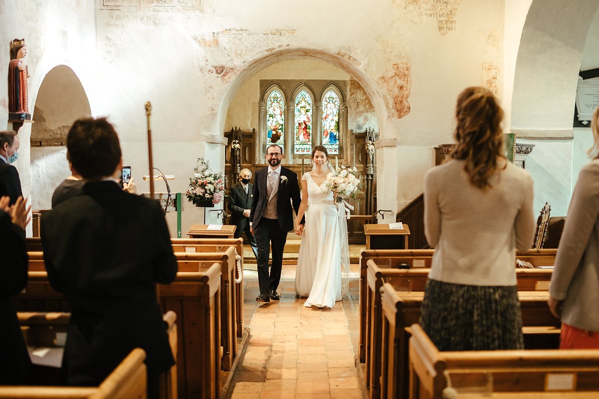 Bride and groom exiting Little Missenden church