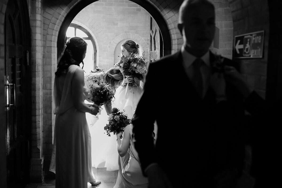 Bride waiting to walk in at St Anselm's church in Tooting Bec