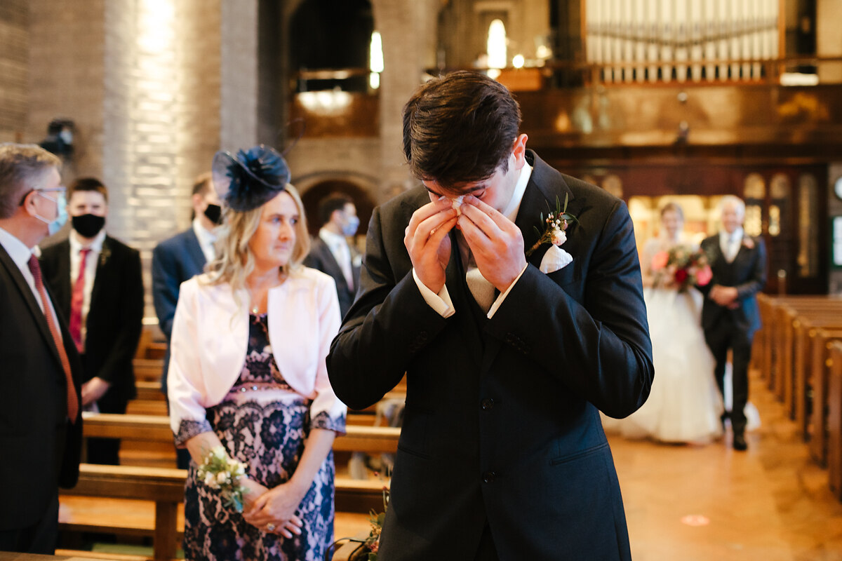 Emotional groom waiting for his bride moment