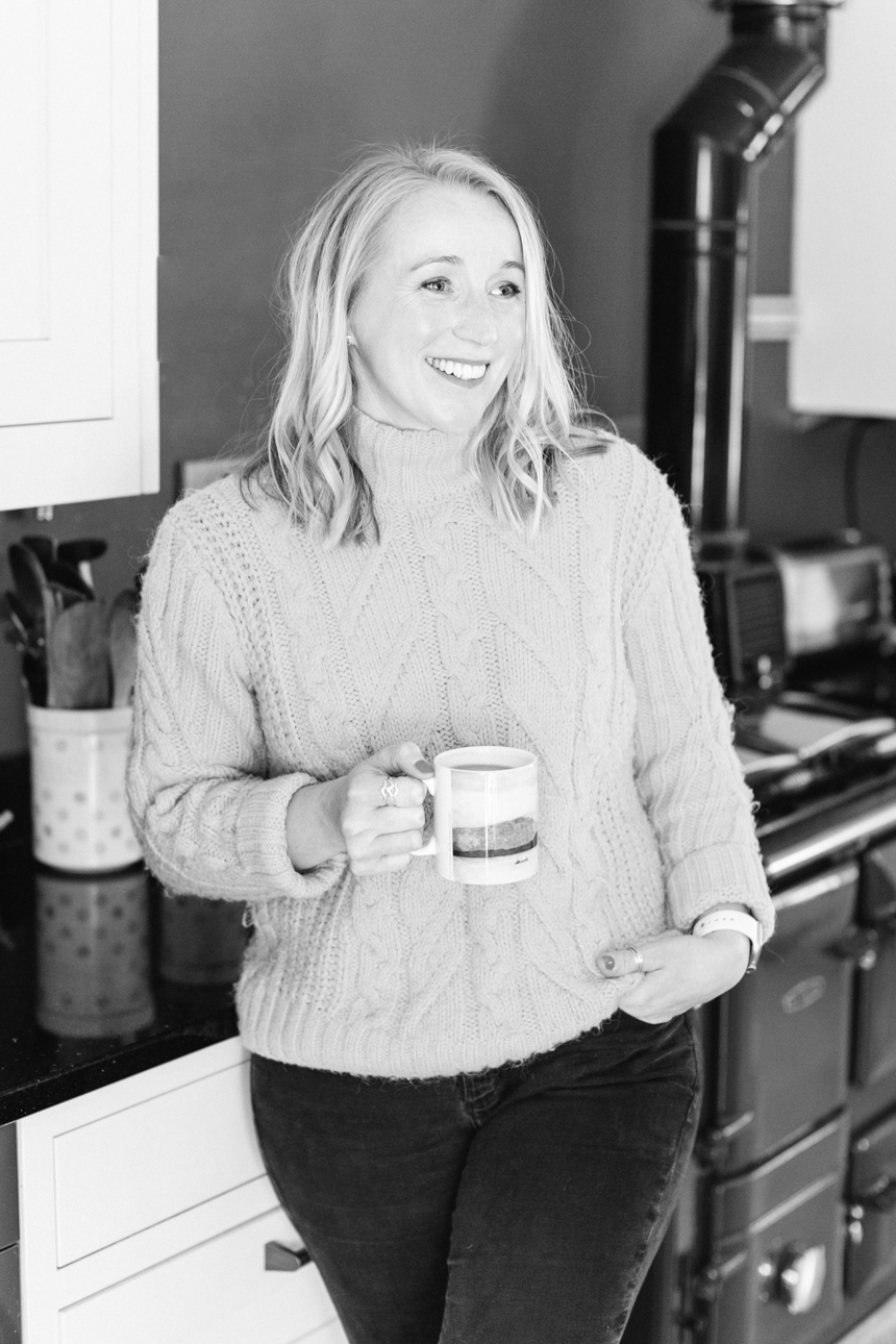 Eneka Stewart standing and drinking tea