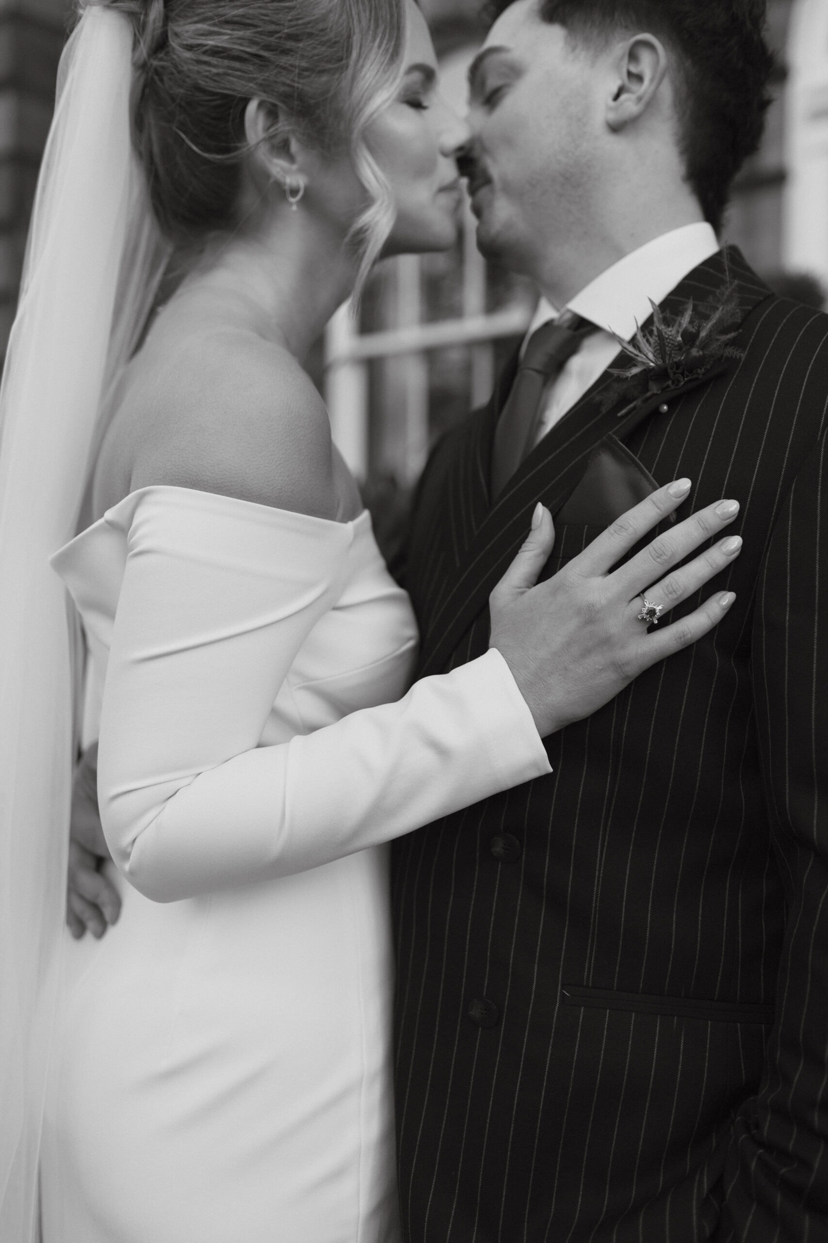 Bride and groom kissing in front of Kimpton Hotel